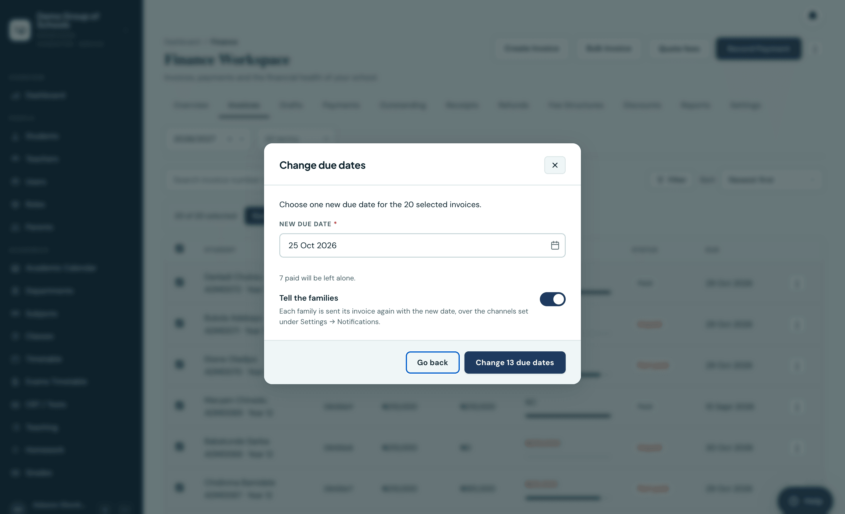 The Change due dates dialog over the Invoices tab, with twenty invoices selected and 25 Oct 2026 chosen: it says 7 paid will be left alone, the Tell the families switch is on, and the button reads Change 13 due dates